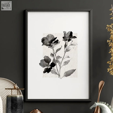 Black-framed wall art prints featuring monochromatic ivory and grey botanical studies on textured paper