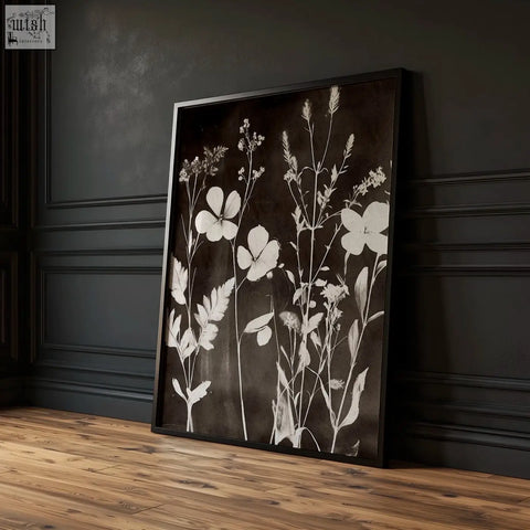 Black-framed abstract nature art print with white floral silhouettes perfect for dining room decor in dark tones