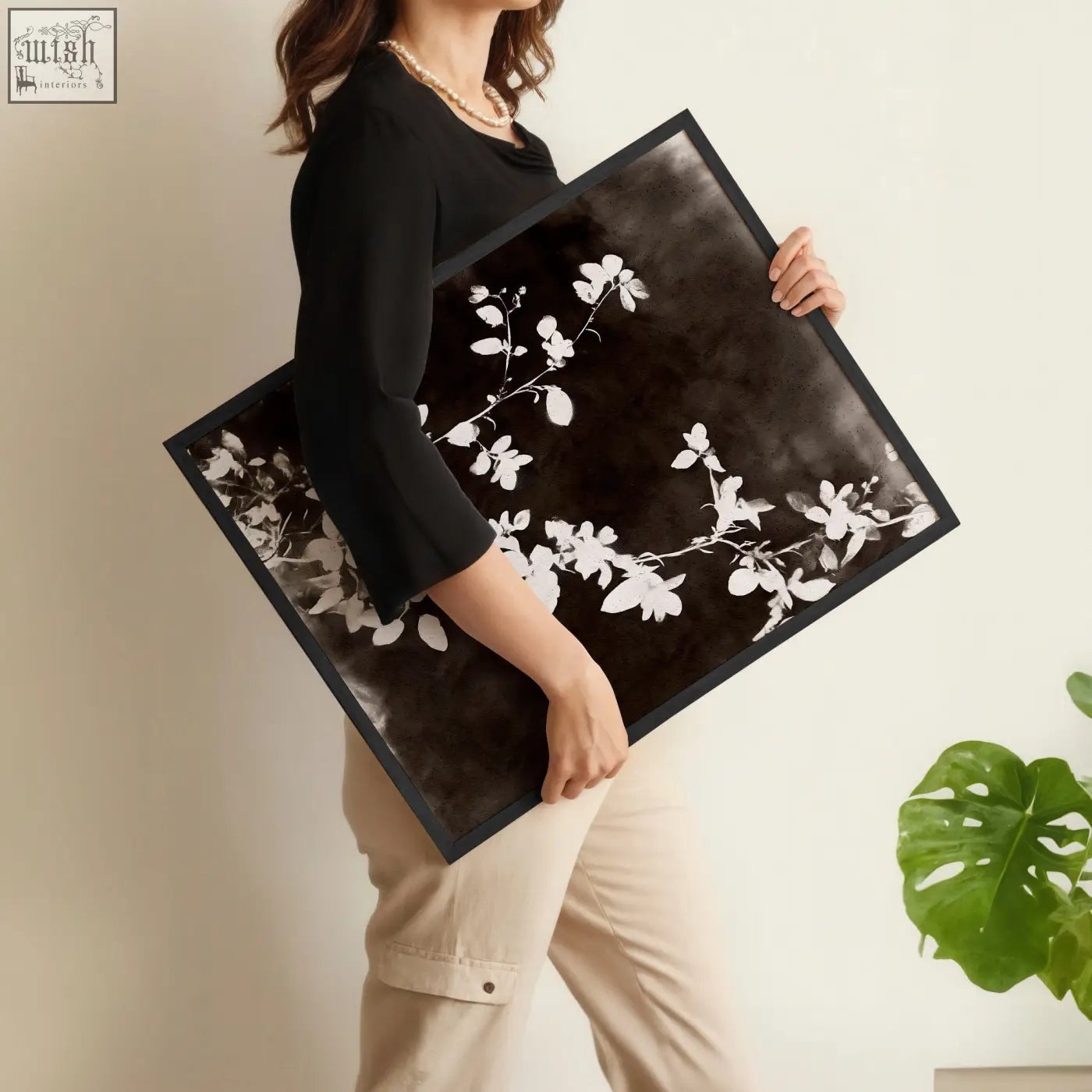 Black-framed abstract nature art with delicate white floral branch on dark background perfect for dining room decor