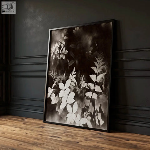 Black-framed abstract nature art print with white leaf silhouettes on dark background perfect for dining room decor