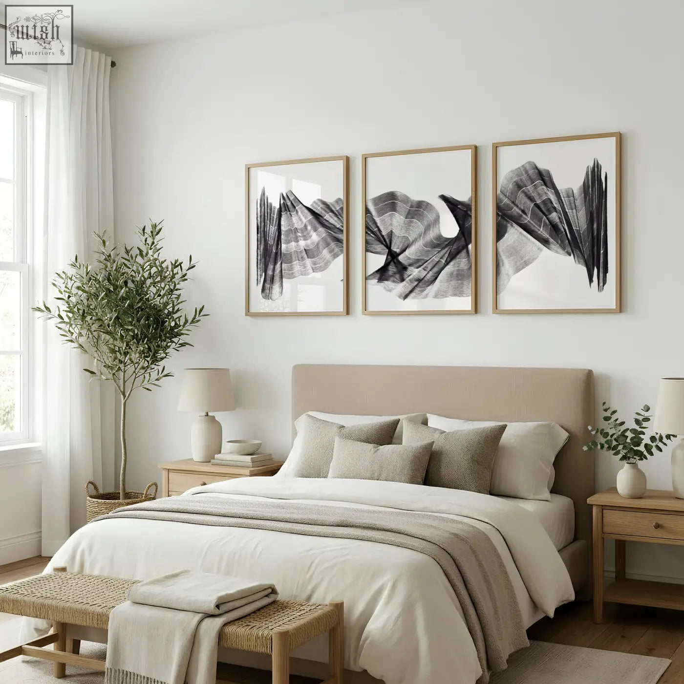 Beige upholstered bed with matching pillows and neutral throw complemented by abstract painting art print set of 3