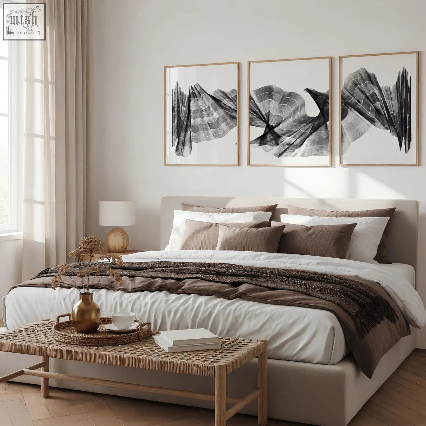 A gold-toned ceramic vase with dried botanicals paired with abstract painting art print charcoal flowing wave set of 3