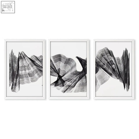 Set of three minimalist black and white abstract painting art prints in sleek white frames with textured wave design