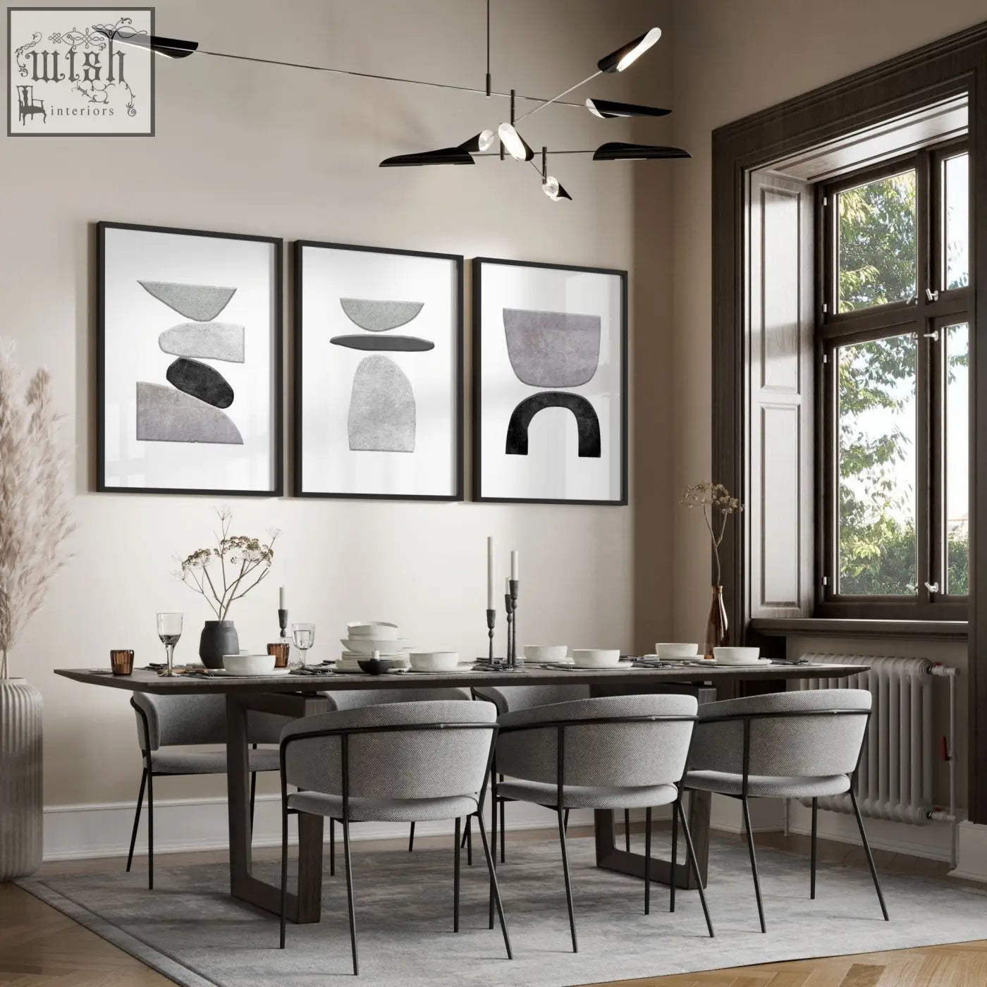 Modern dining table with dark wood surface and black metal legs surrounded by gray chairs below abstract black and white wall art prints set of 3