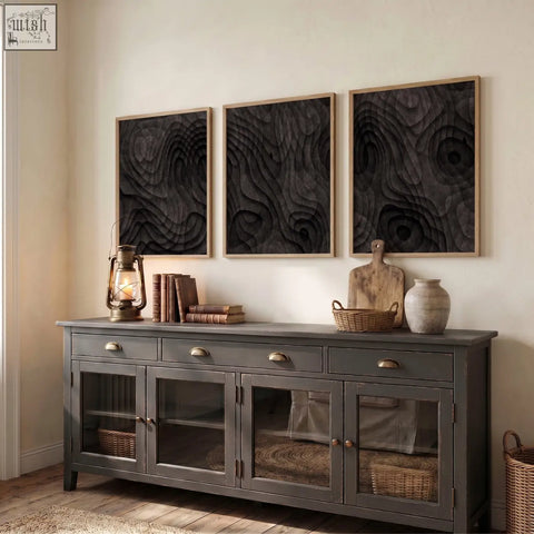 Dark gray wooden sideboard with brass handles and glass cabinets shown beside abstract painting dark charcoal topographic wave prints set of 3