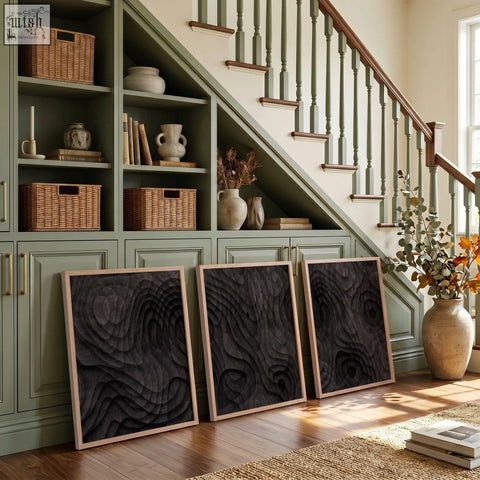 Three framed abstract painting prints with dark charcoal topographic wave texture and natural wood frames