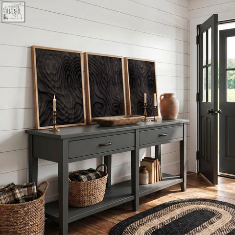 Dark gray console table with rustic wooden top and black metal handles paired with abstract dark charcoal topographic wave art