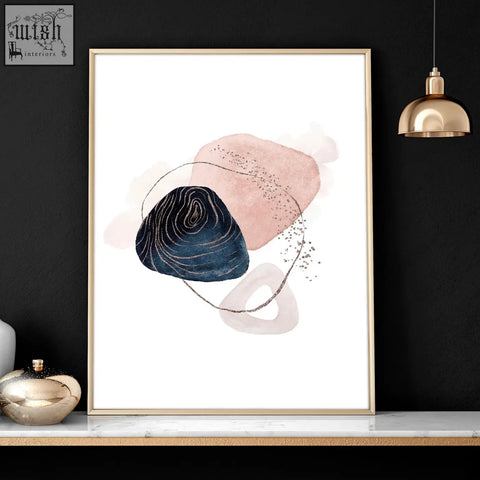 A set of 3 abstract art prints featuring soft pink and navy shapes with gold accents in slender gold frames for bedroom wall art