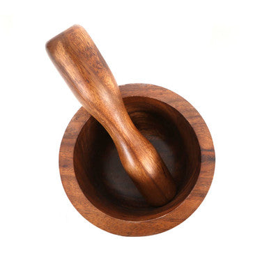 A polished acacia wood round mortar and pestle with smooth grain patterns from kora small mortar set