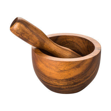 A rustic small mortar and pestle set made from warm acacia wood in a natural finish by kora