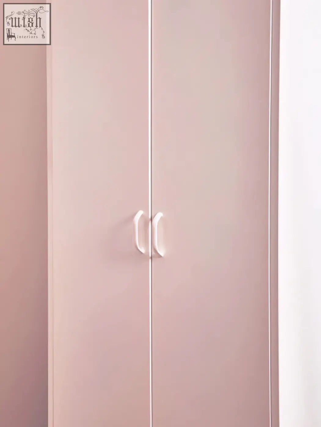 A sleek pastel pink wardrobe with minimalist white handles styled like the academy white two-door locker style