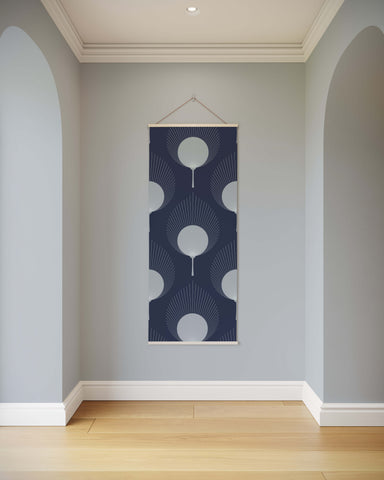 A navy blue ace fan leaf tapestry with white art deco circular patterns framed by a thin wooden border hanging on wall