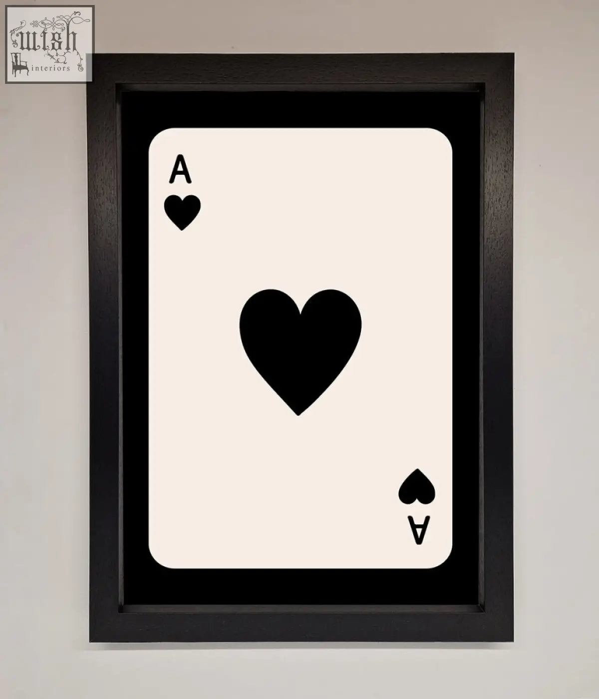 Black-framed ace of hearts framed poster with bold black heart symbols on a cream-colored background