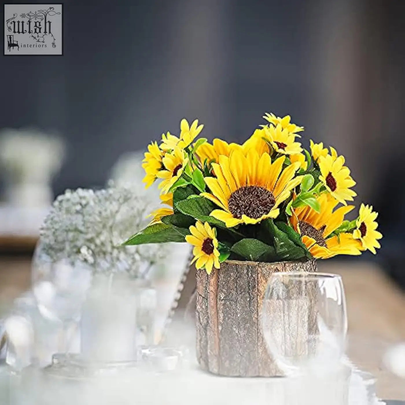 A vibrant bouquet of artificial sunflowers with bright yellow petals in a rustic wooden log vase for indoor decor