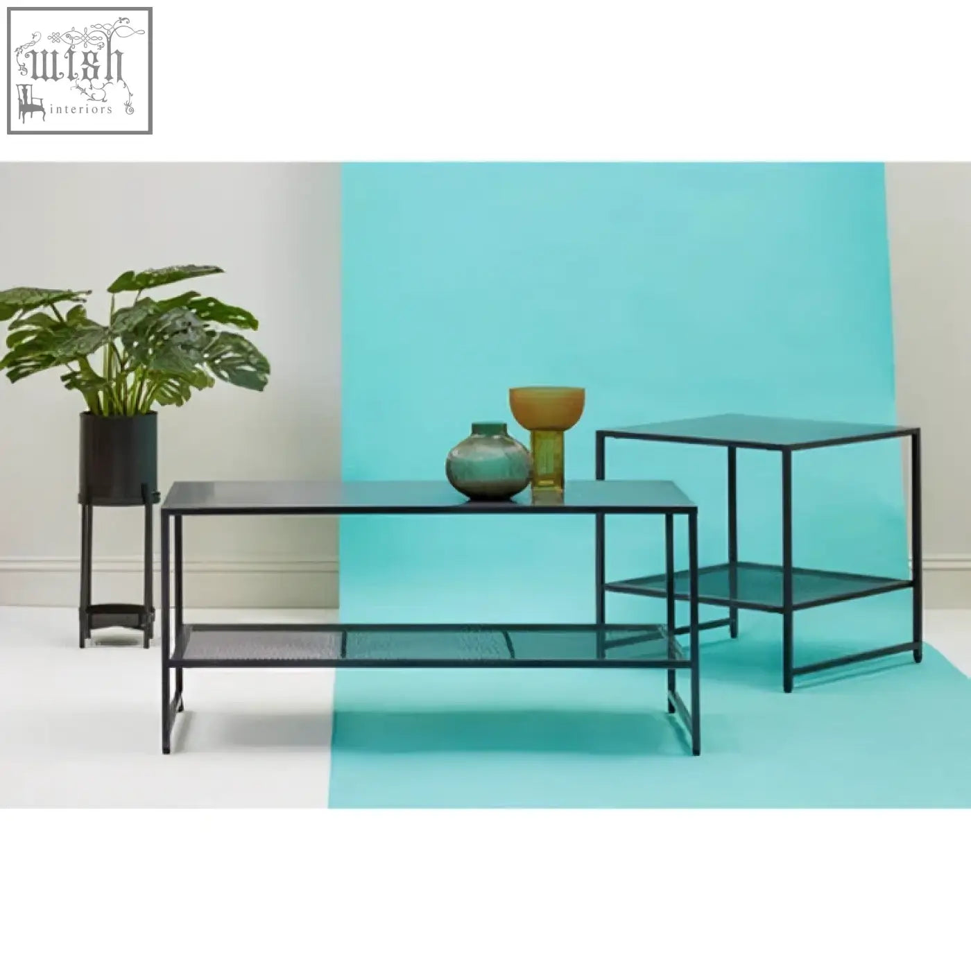 Black metal coffee table with glass shelves and mesh lower shelf in a sleek black metal frame design
