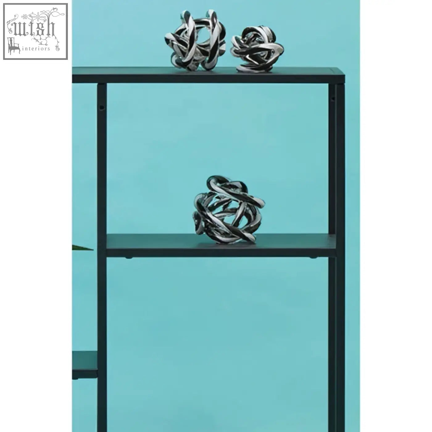 Silver metallic knot sculptures displayed on an acero black metal multi shelf unit with black metal frame