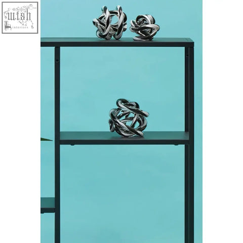 Silver metallic knot sculptures displayed on an acero black metal multi shelf unit with black metal frame