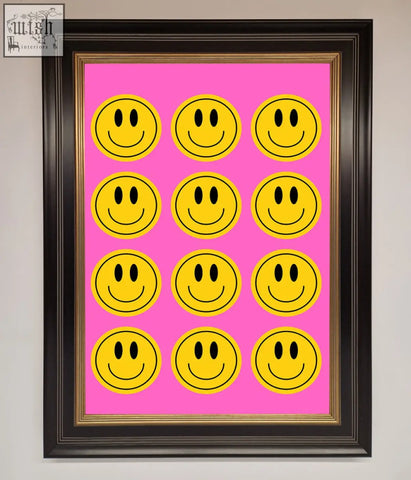 A framed poster with a vibrant pink background and twelve bold yellow smiley faces in four rows of three