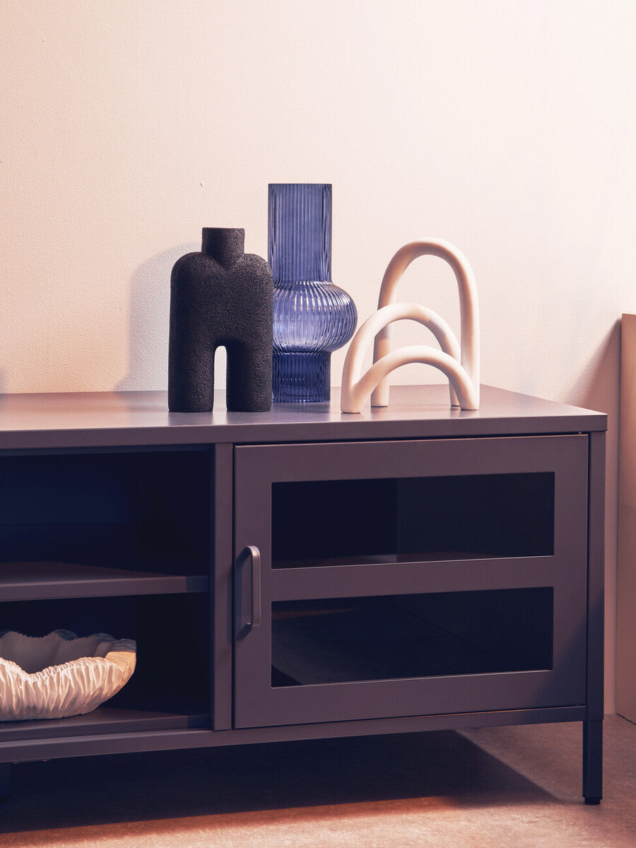 Dark gray metal media unit with glass-paneled door and open shelf perfect for grey metal media storage