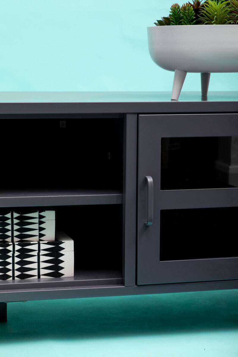 Dark gray metal media console with glass doors and minimalist handle featured in acier two door grey metal media unit
