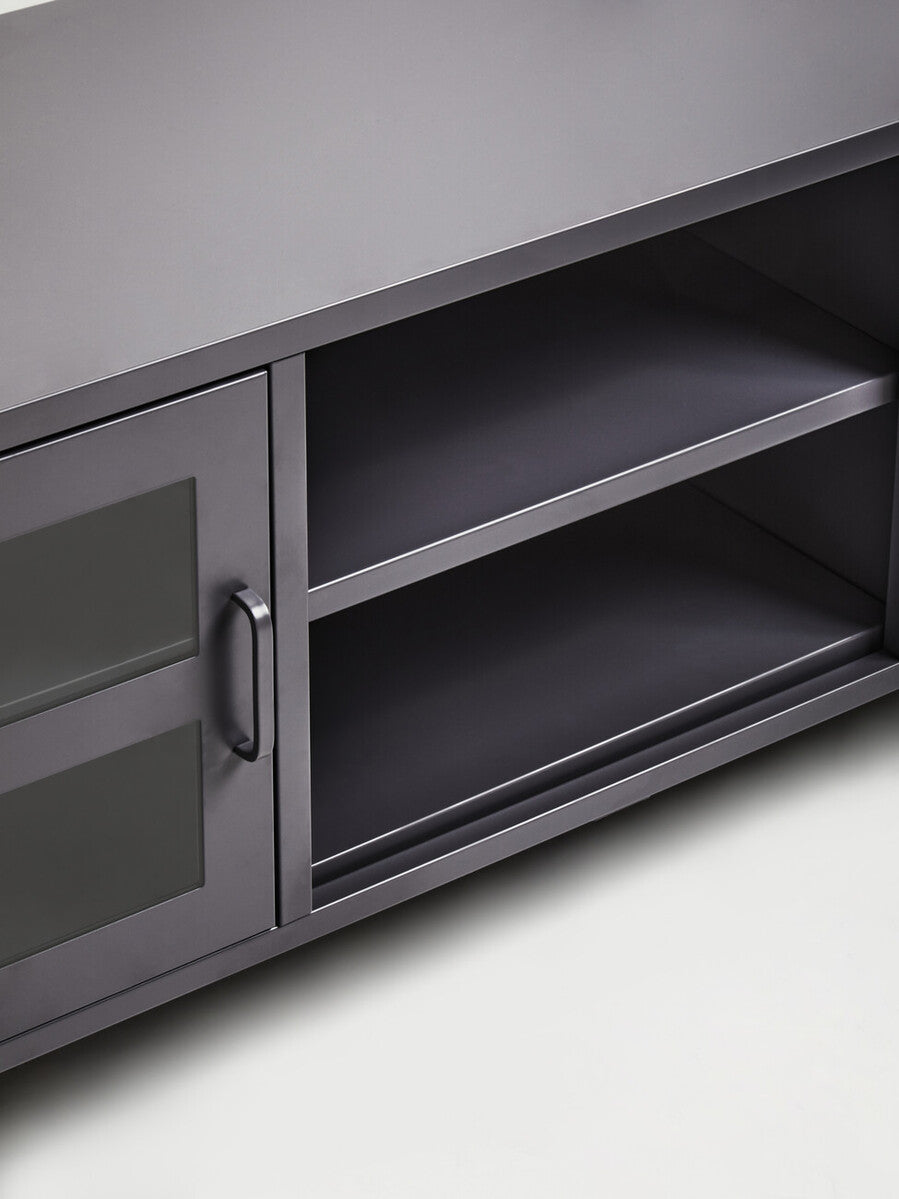 Dark gray metal media unit with glass-paneled door and open shelving for stylish grey metal media storage