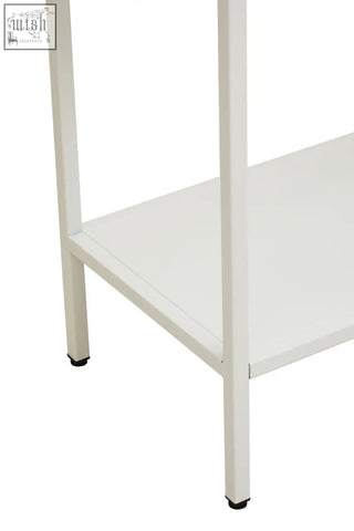 White metal cabinet with glass doors featuring a minimalist design and black rubber feet on a metal cabinet unit