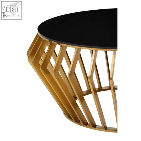 Ackley gold round coffee table with a gold-toned geometric metal frame and sleek black glass top
