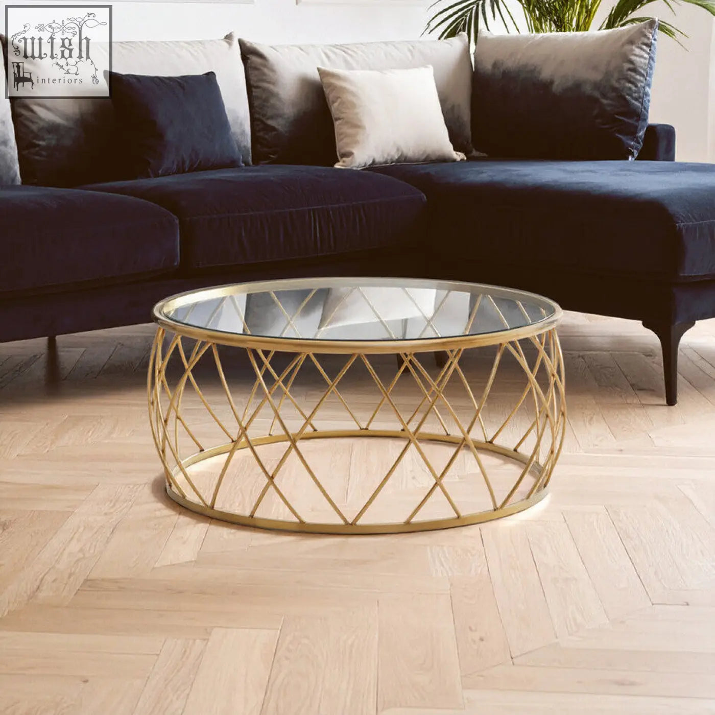 Ackley gold round coffee table with a gold-toned geometric metal frame and clear glass top for stylish living spaces