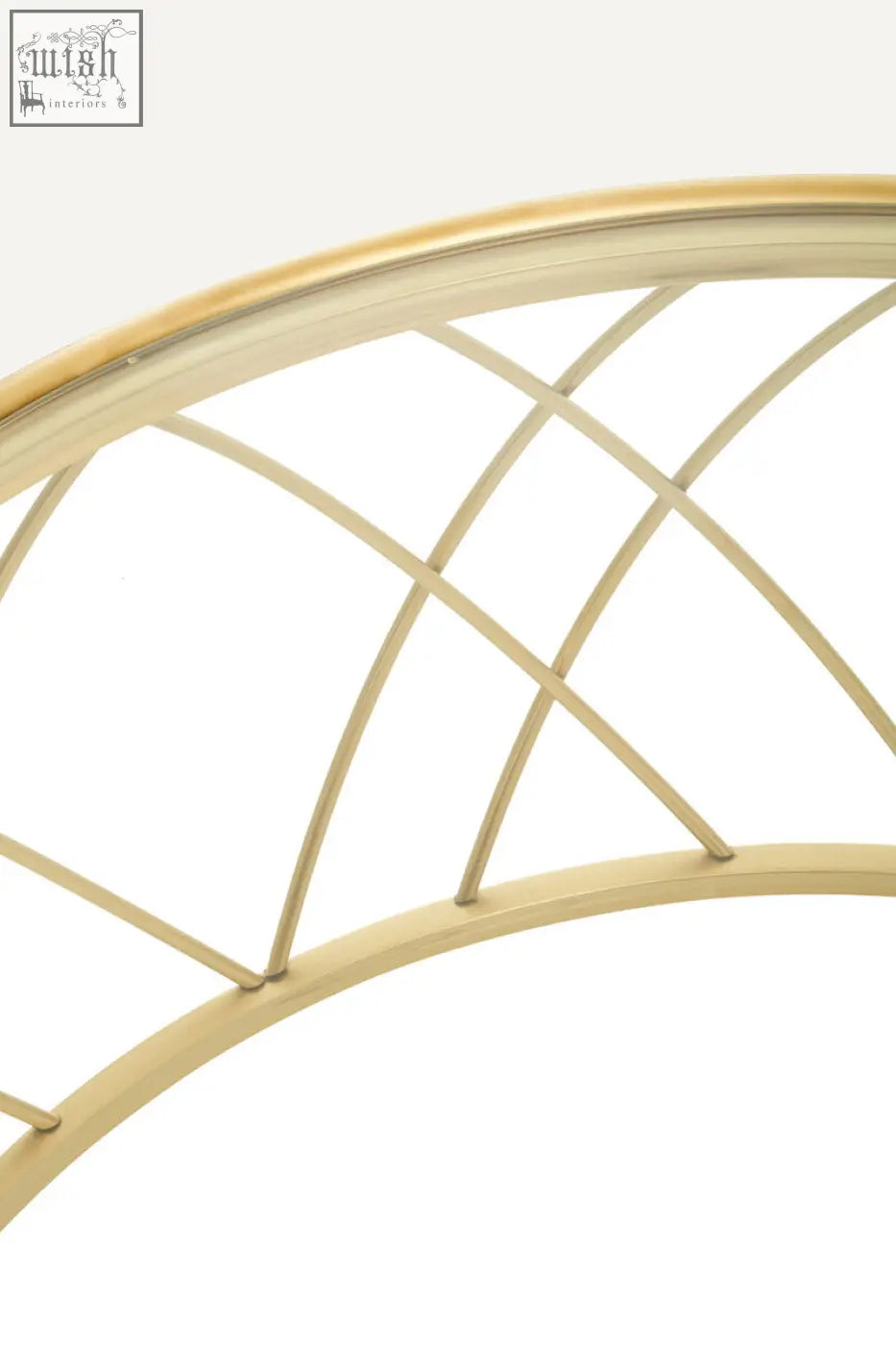 Gold-toned metal arched mirror frame with delicate crisscross lattice design complements ackley gold round coffee table with clear glass