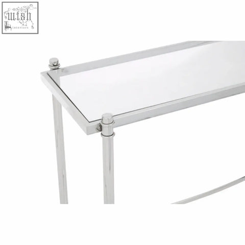 Ackley silver console table with clear glass top and stainless steel frame featuring polished chrome legs and finials