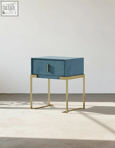 Blue leather Acton bedside table with gold metal legs and minimalist drawer handle for a stylish table set
