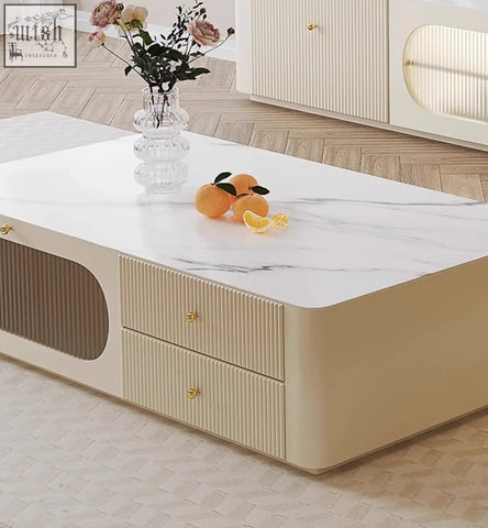 Cream-colored adelaide tv stand coffee table with white marble top and ribbed drawers in pine wood and gold handles