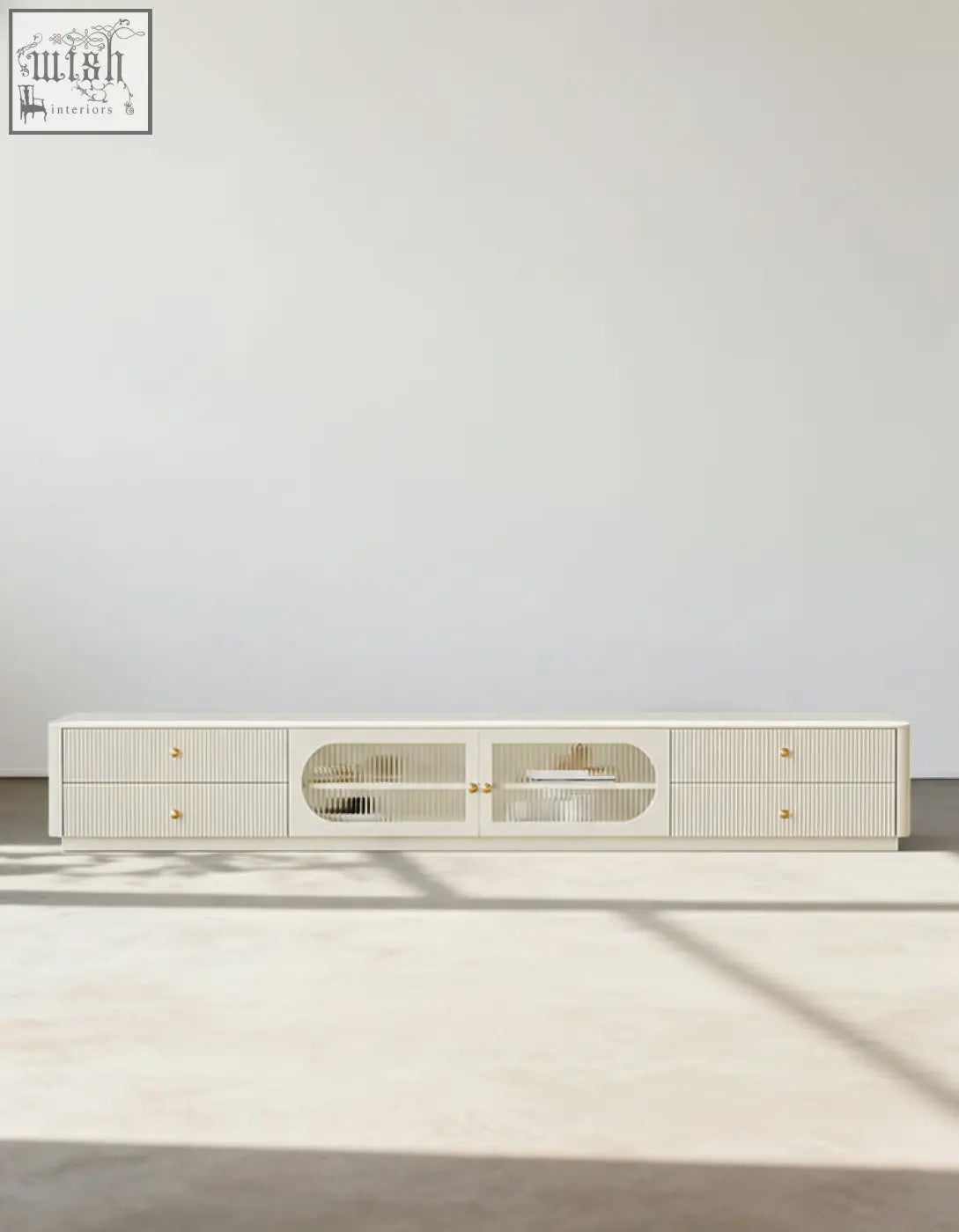 Cream-colored adelaide tv stand made of pine wood with vertical slat detailing and gold-toned hardware