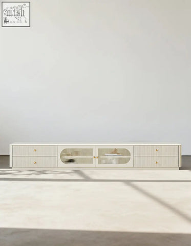 Cream-colored adelaide tv stand made of pine wood with vertical slat detailing and gold-toned hardware