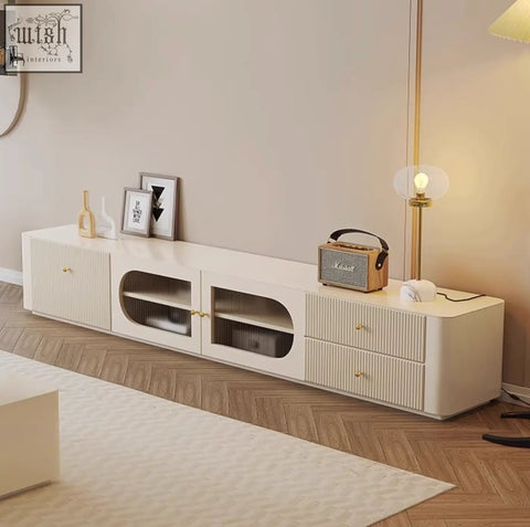 Cream-colored adelaide tv stand with vertical ribbed texture, glass oval compartments, gold hardware, made of pine wood