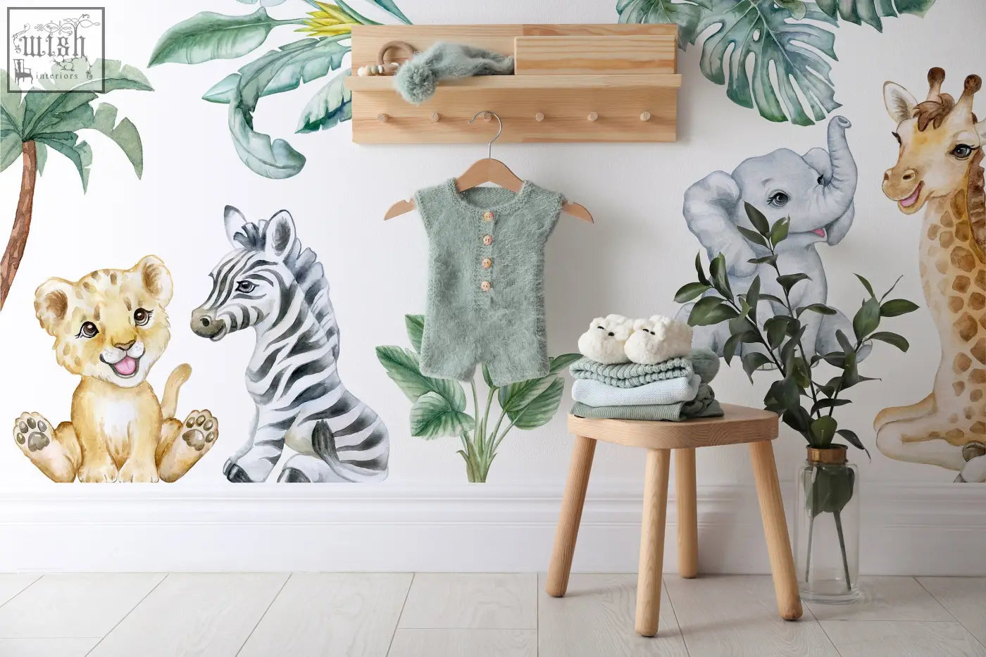 Mint green textured knit baby romper with button closures hanging on wooden hanger for kids room with safari wall decals and african animals stickers