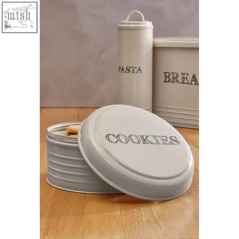 Cream-colored metal lucky dog food storage jar with ribbed lid and cookies embossed for dog food storage