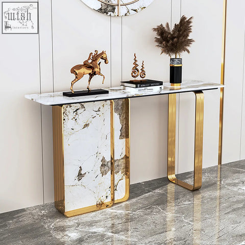 Aeta console table with white marble top and gold metal legs featuring vertical marble panels between legs