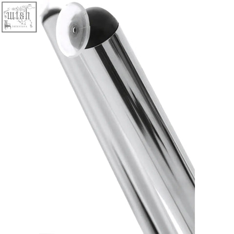 Chrome finished metal pole with black suction cup attachment on afton round dining table with glass top and cross base