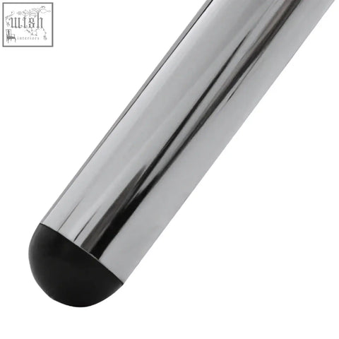 A sleek metallic stylus with a black rubberized tip resting on the afton round dining table with glass top and cross base