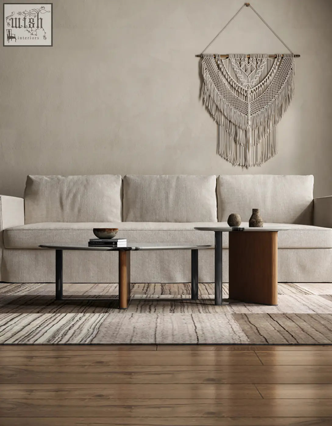 Beige macramé wall hanging with intricate woven patterns and long fringe shown with agatha nesting coffee table setup