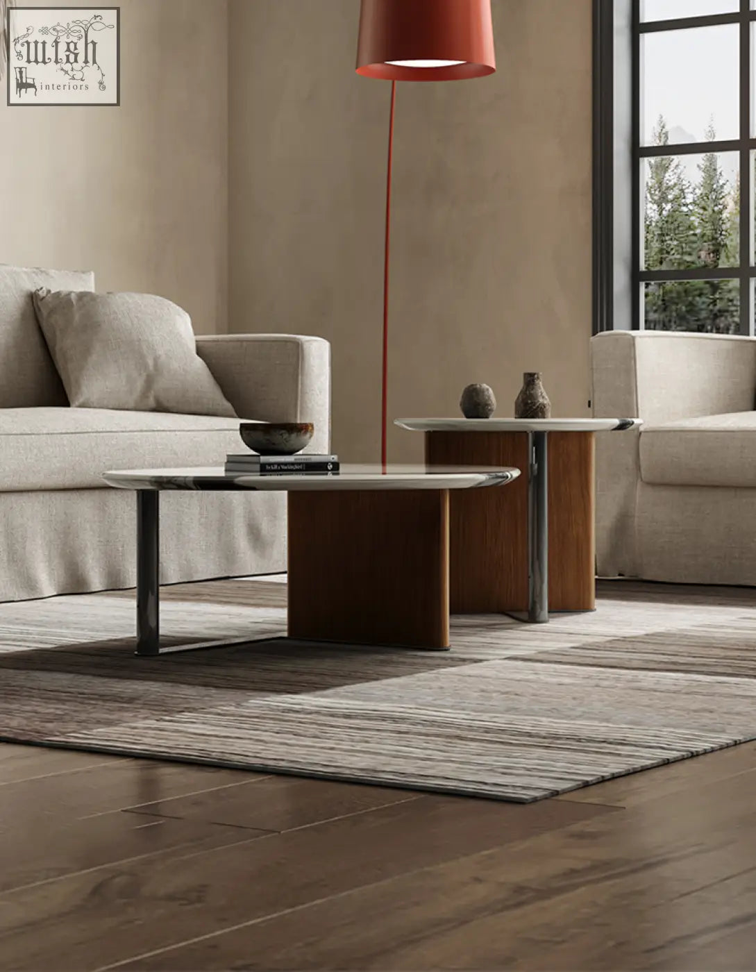 Modern agatha nesting coffee table with oval polished marble top and sleek metal legs in neutral tones