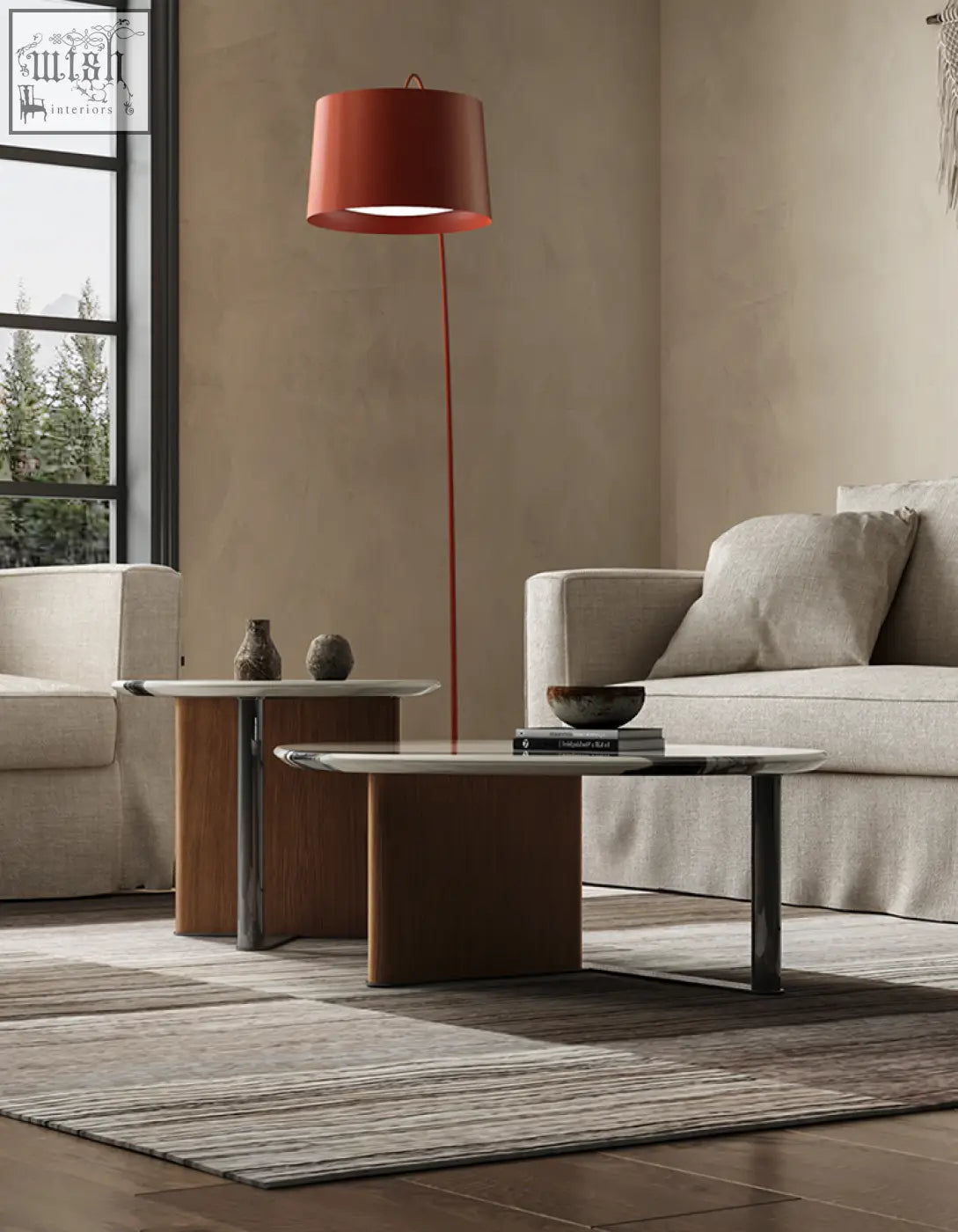 A sleek modern floor lamp with a red shade beside the agatha nesting coffee table with metallic legs