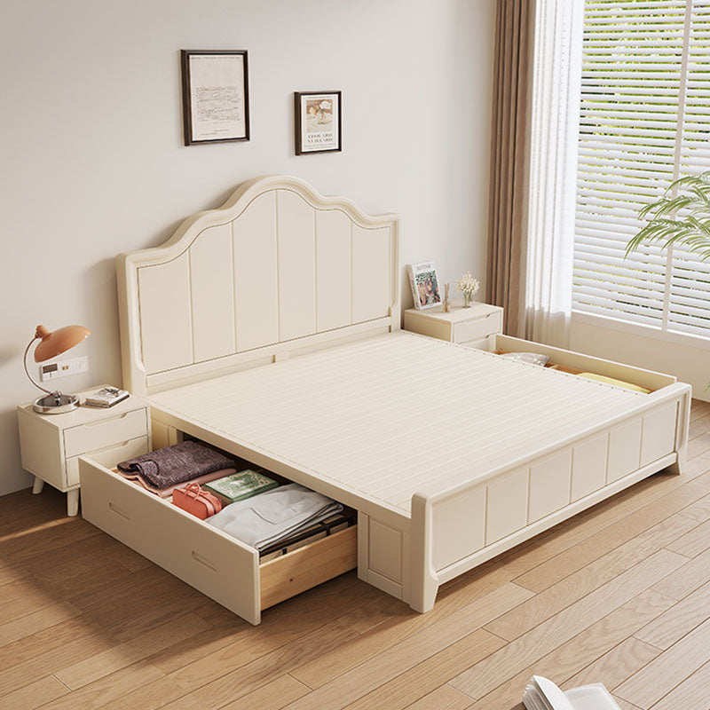 Cream-colored wooden agnes king size bed with curved headboard and built-in storage drawers for super king size use
