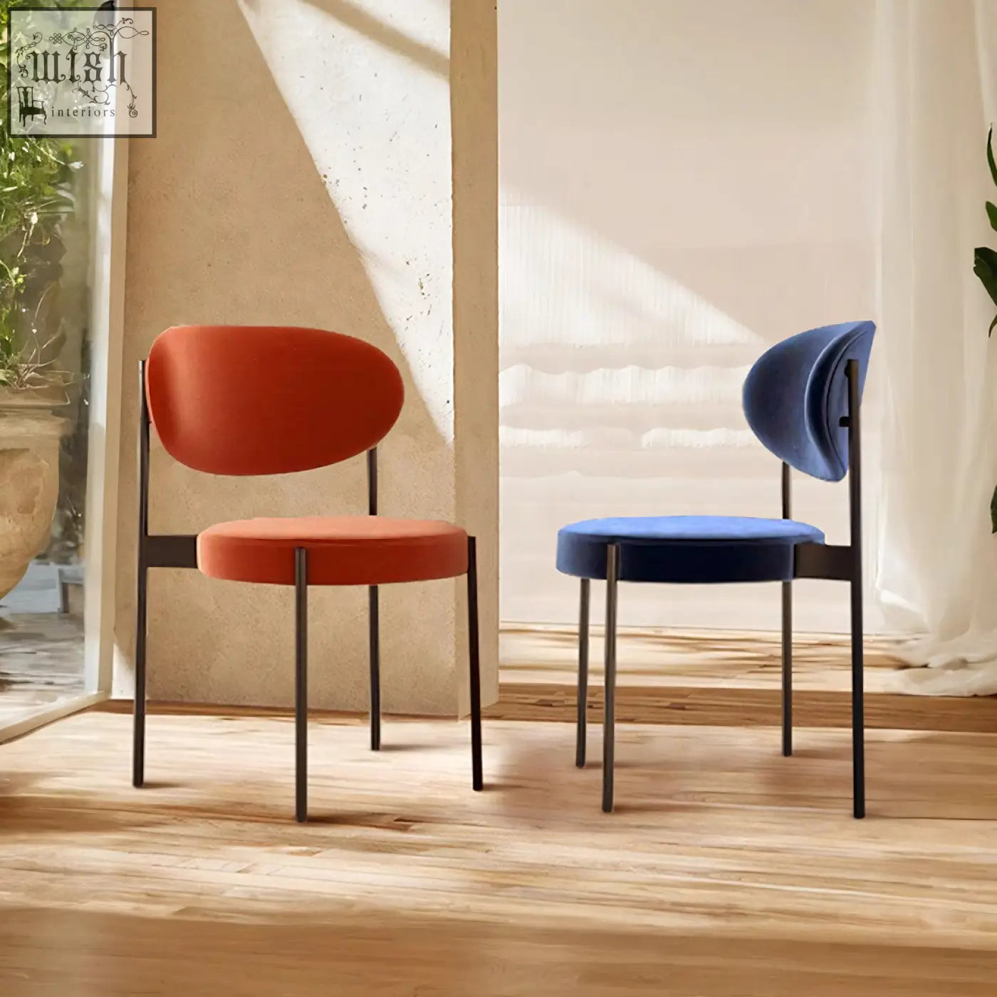 Modern minimalist ahmed dining chairs with sleek black metal frames and plush orange and navy blue velvet seats