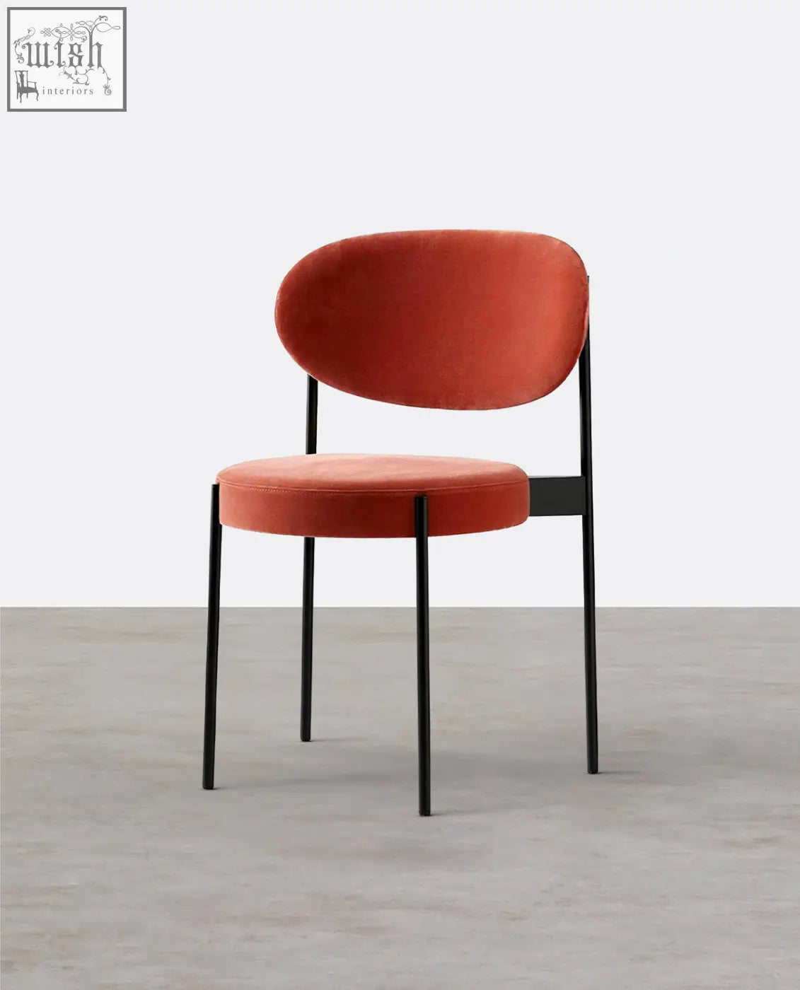 Ahmed dining chair with plush burnt orange velvet seat and backrest and sleek black metal legs for dining use