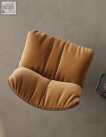 A plush caramel velvet swivel lounge chair with segmented cushioning and a modern minimalist design