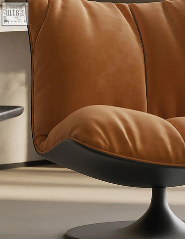 A plush caramel velvet swivel lounge chair with a sleek black pedestal base perfect for relaxing spaces