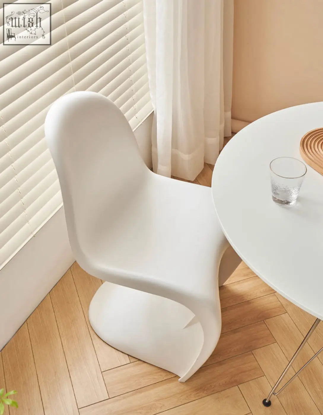 White molded plastic aimee dining chair with sleek modern curves perfect as a stylish dining chair