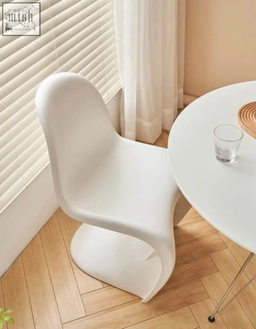 White molded plastic aimee dining chair with sleek modern curves perfect as a stylish dining chair